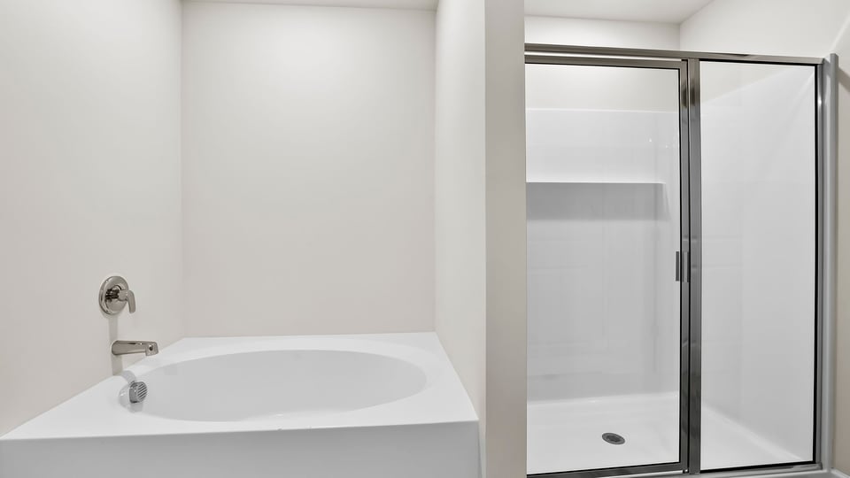 Bathroom with bathtub and walk in shower.