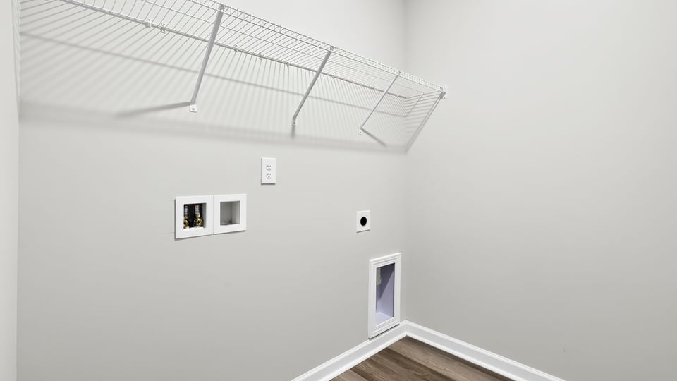 Laundry room with hanging storage racks.
