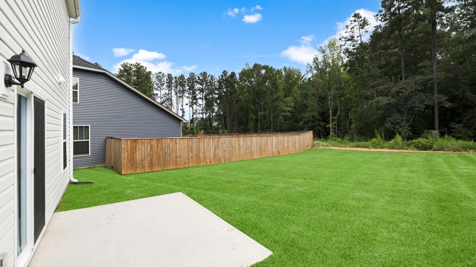 Back exterior of home with patio.