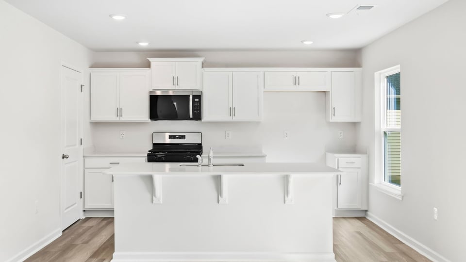 Kitchen and island with quartz countertops.