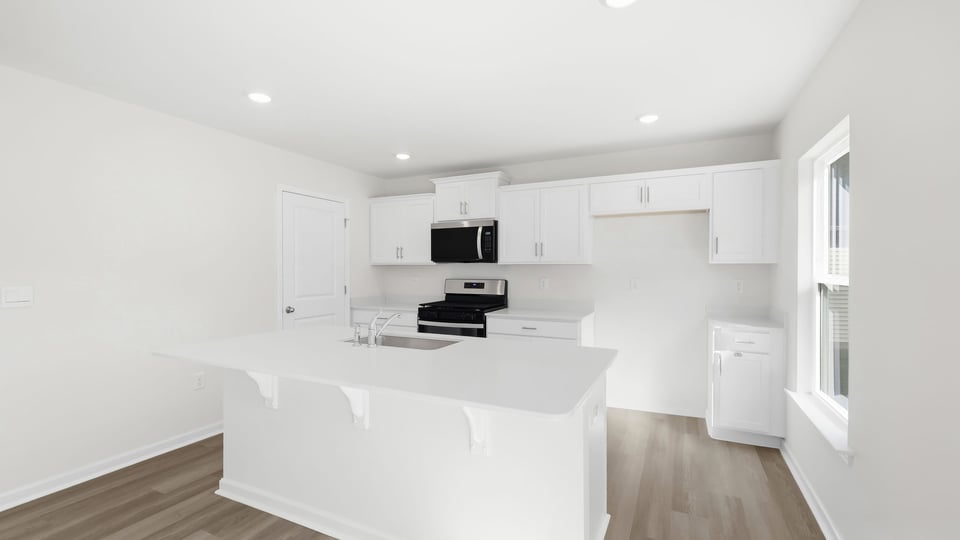 Kitchen and island with quartz countertops.