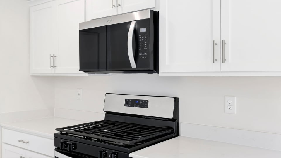 Kitchen and island with quartz countertops.