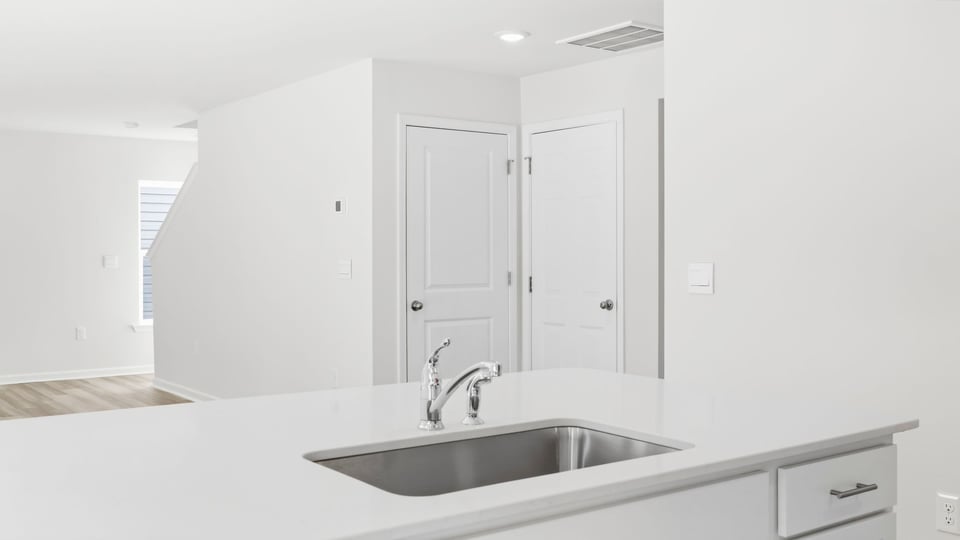 Kitchen and island with quartz countertops.
