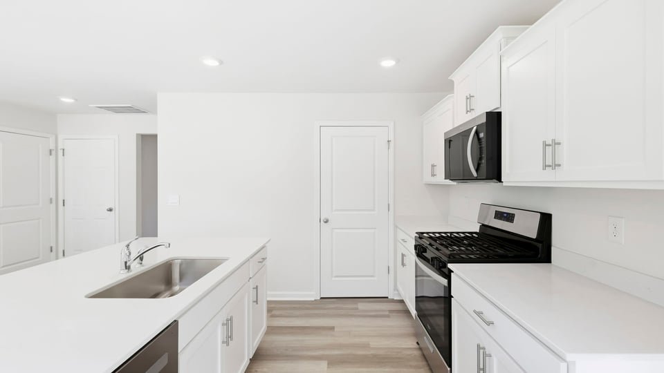 Kitchen and island with quartz countertops.