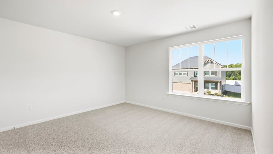 Bedroom with carpet and window.