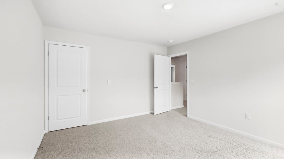 Bedroom with carpet and window.