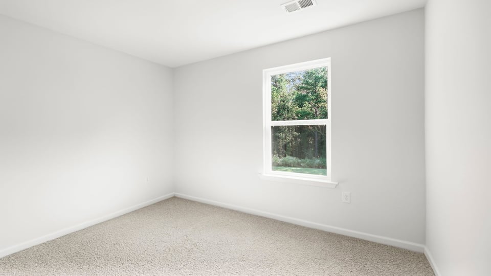 Bedroom with carpet and window.