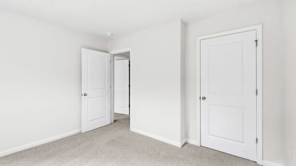 Bedroom with carpet and window.
