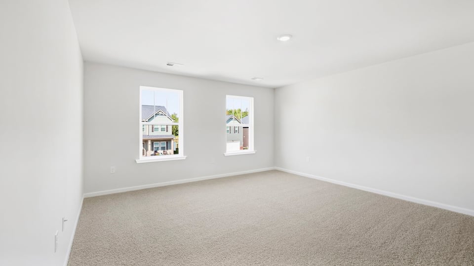 Bedroom with carpet and window.