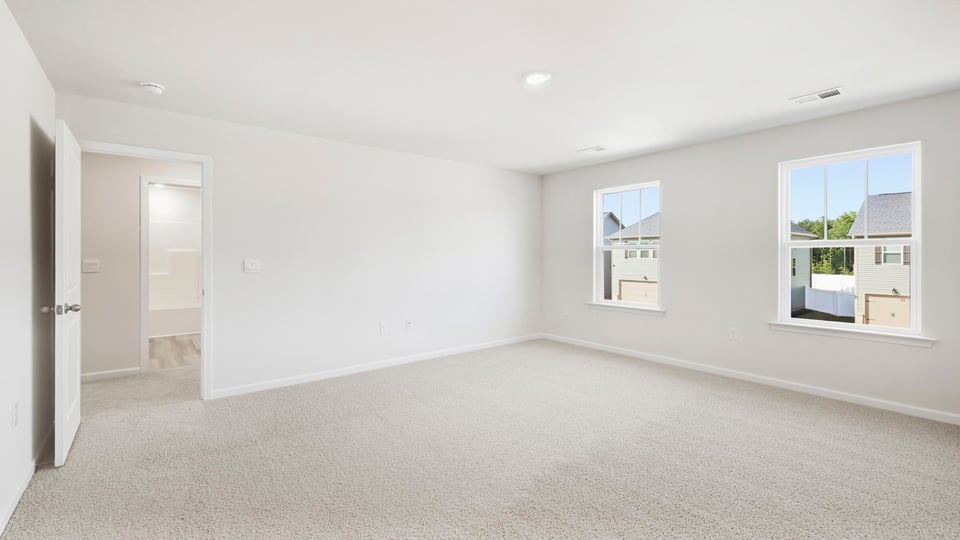 Bedroom with carpet and window.