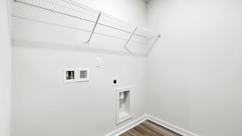 Laundry room with hanging storage racks.
