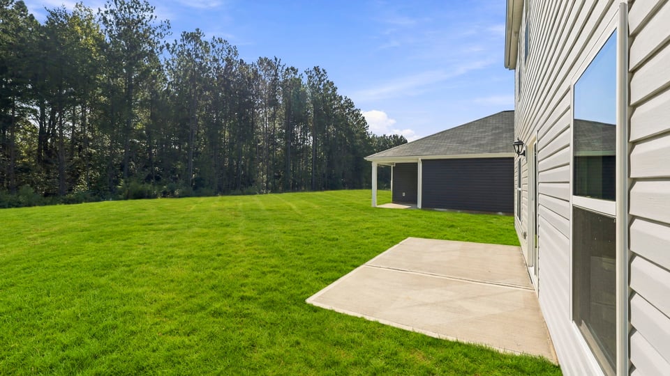 Back exterior of home with covered patio.