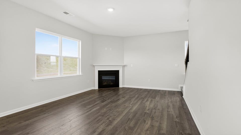 Livingroom with fireplace and windows.