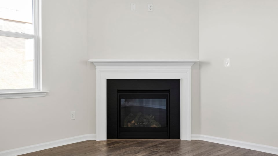 Livingroom with fireplace and windows.