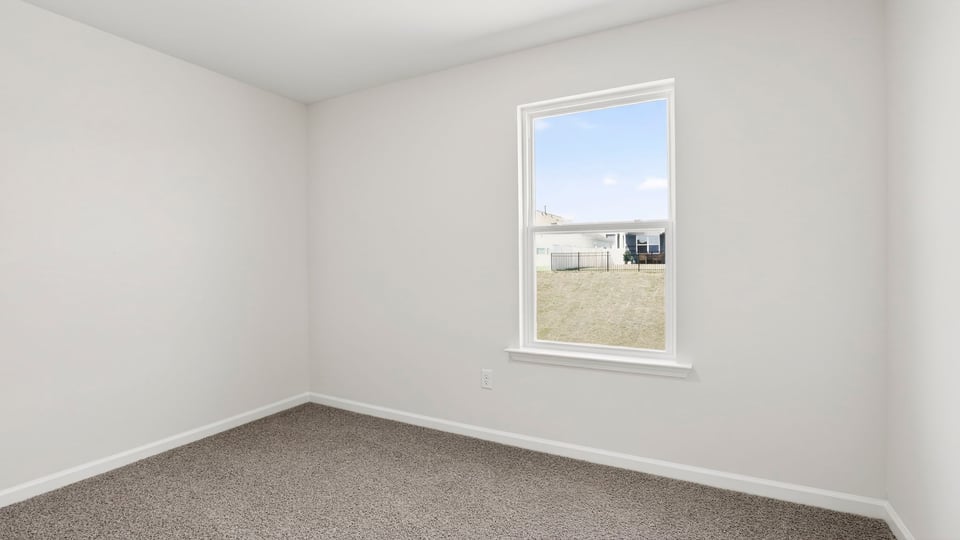 Bedroom with carpet and windows.