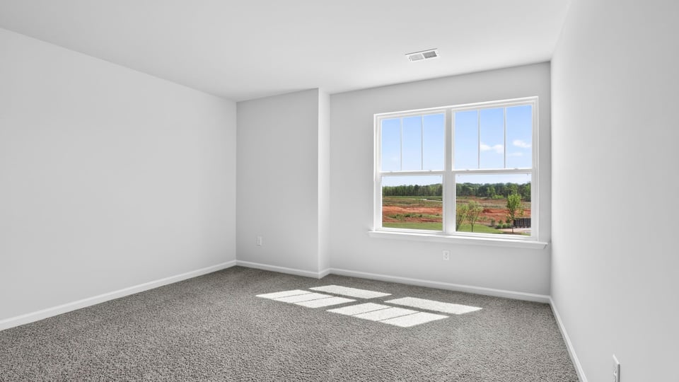 Bedroom with carpet and windows.