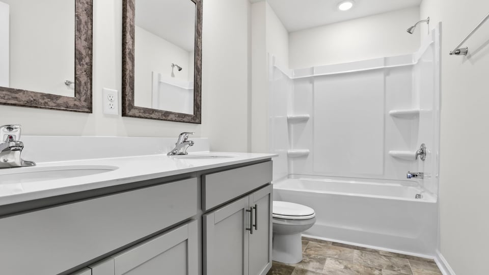 Bathroom with double vanity and tub.