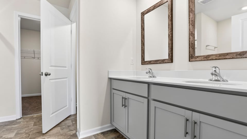 Bathroom with double vanity and tub.