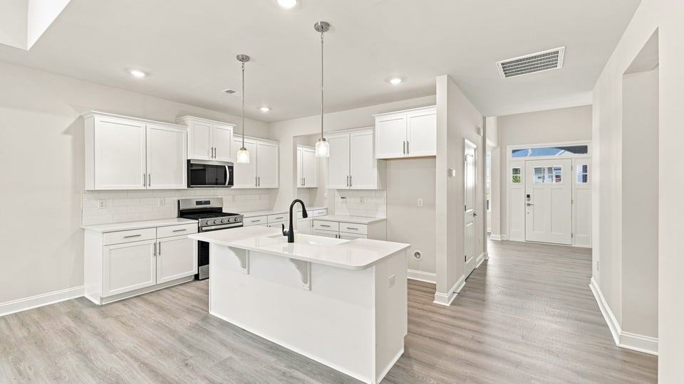 Kitchen with island and cabinets.