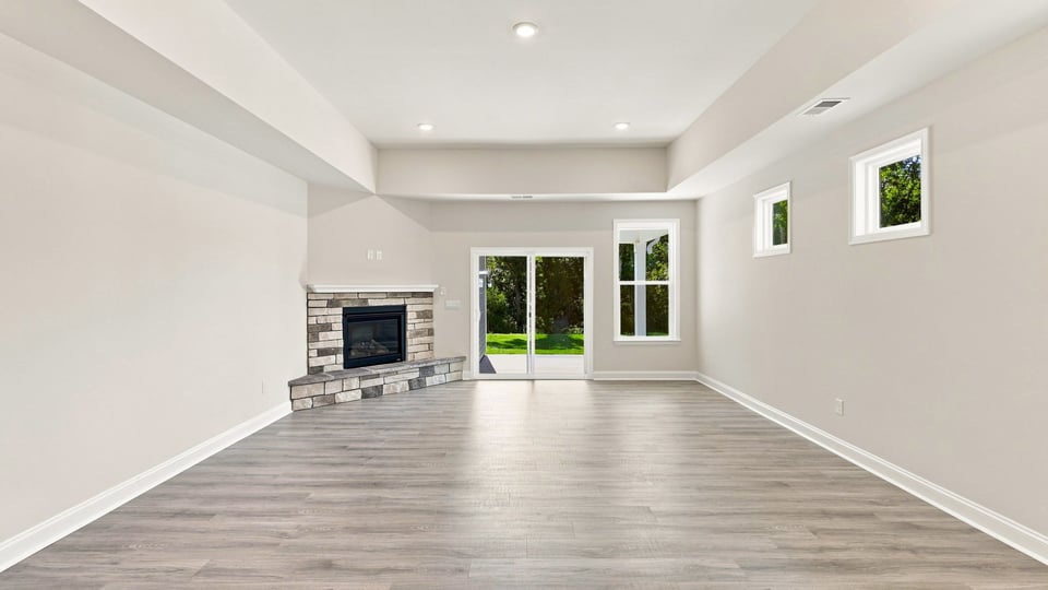 Living room with fireplace and windows.