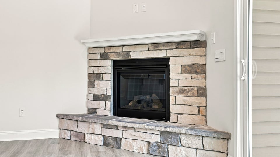 Living room with fireplace and windows.