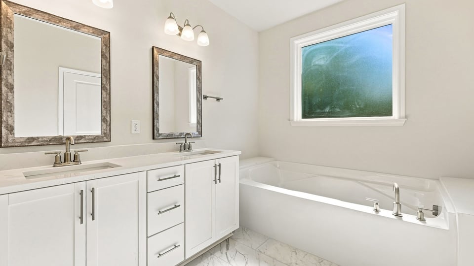 Primary bathroom with double vanity sinks.
