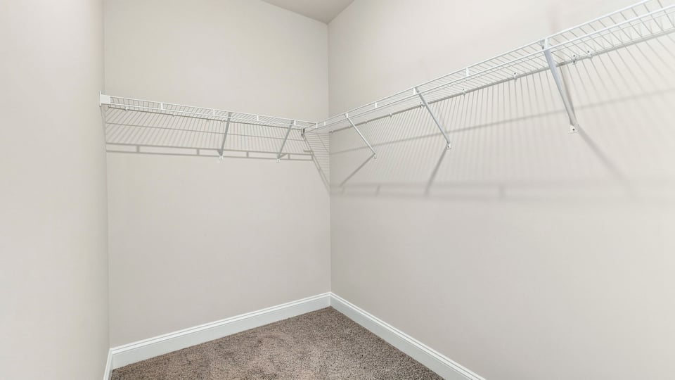 Primary closet with shelf.
