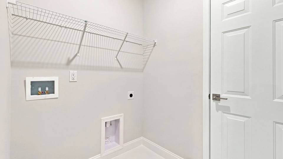Laundry room with shelf.