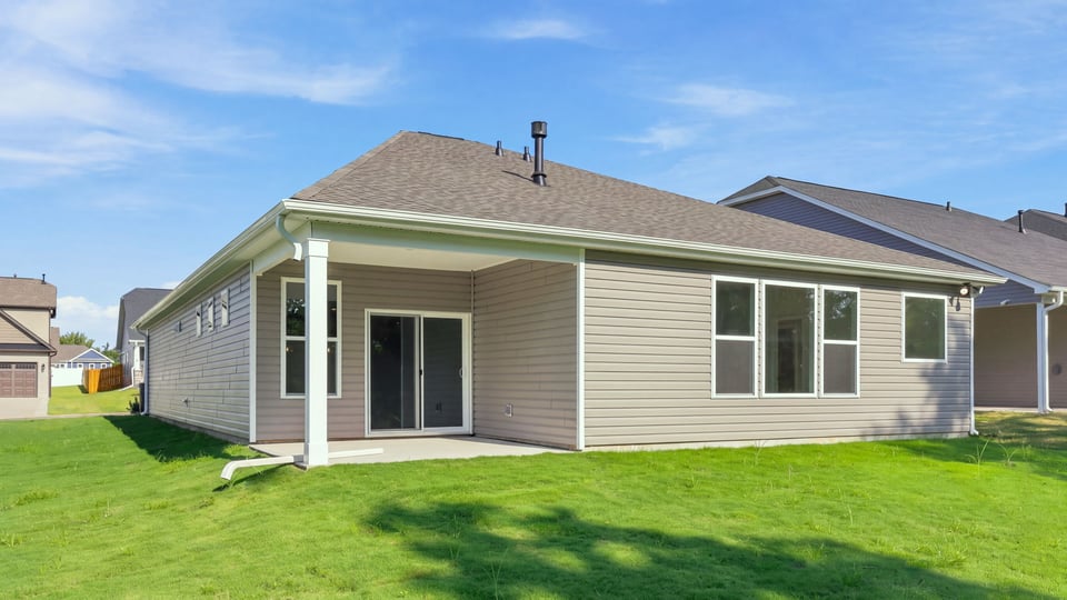 Back exterior with large backyard.
