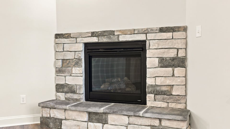 Living area with fireplace and window.