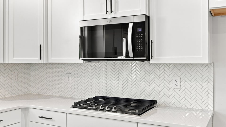 Kitchen with island and cabinets.