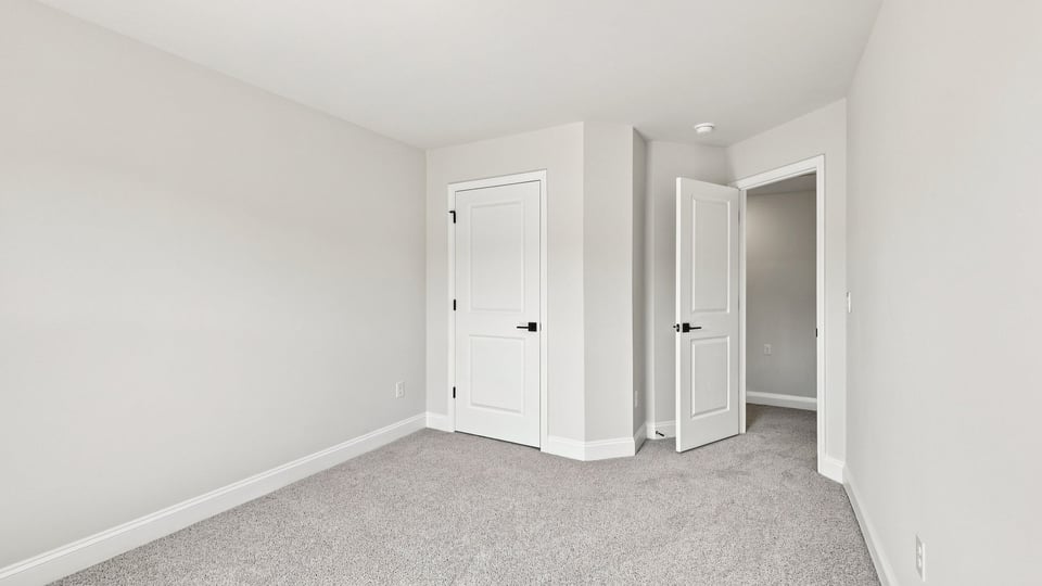 Bedroom with carpet and windows.