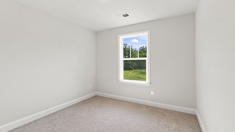 Bedroom with carpet and windows.