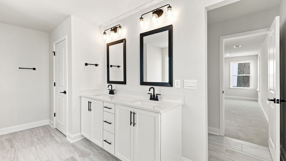 Bathroom with vanity sinks.