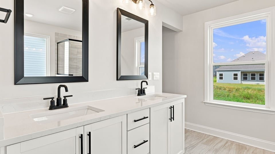 Bathroom with vanity sinks.