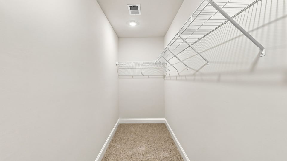 Primary closet with shelf.