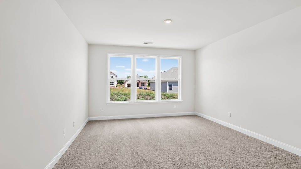 Bedroom with carpet and window.