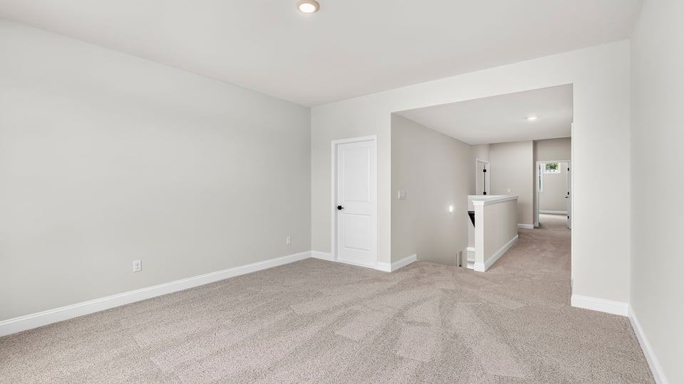 Bedroom with carpet and window.