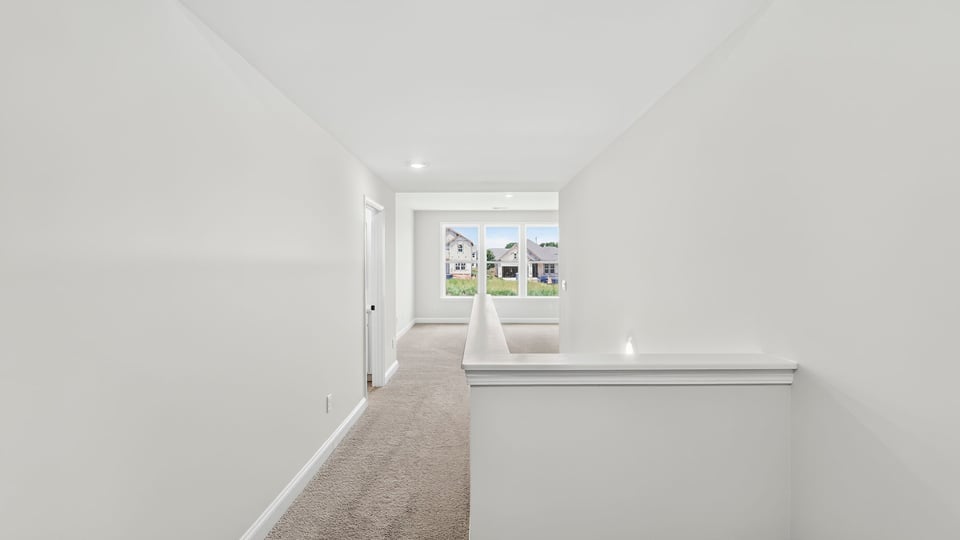 Bedroom with carpet and window.