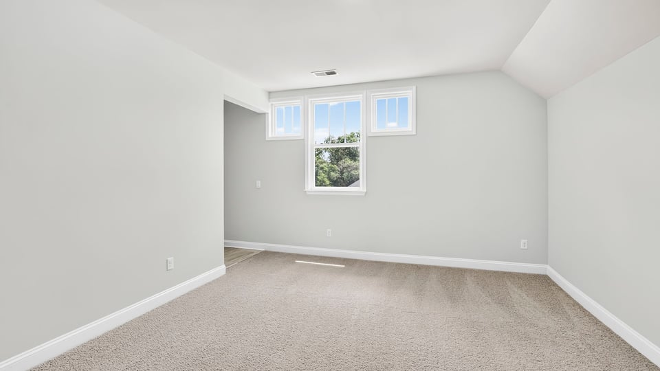 Bedroom with carpet and window.
