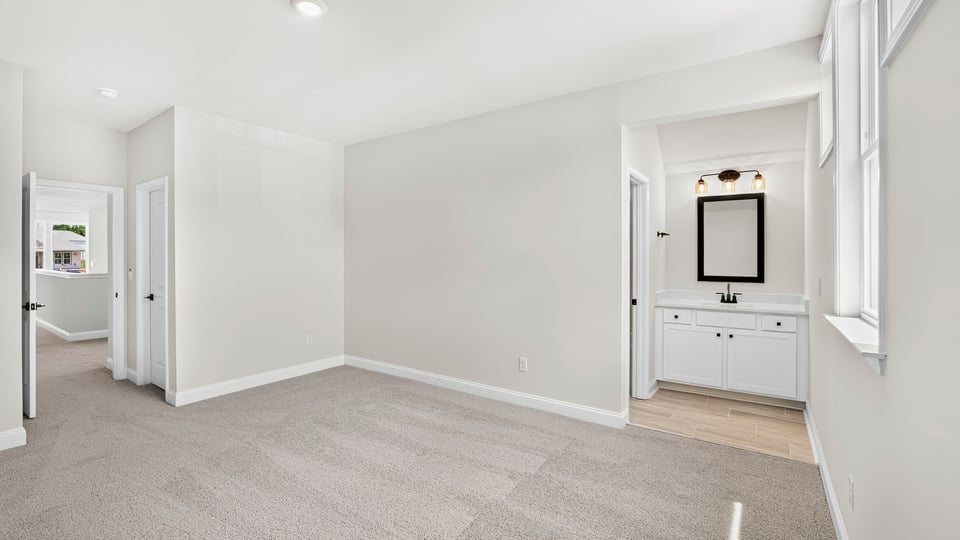 Bedroom with carpet and window.