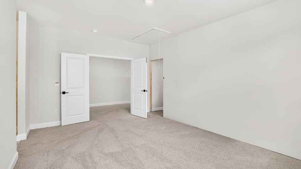 Bedroom with carpet and window.