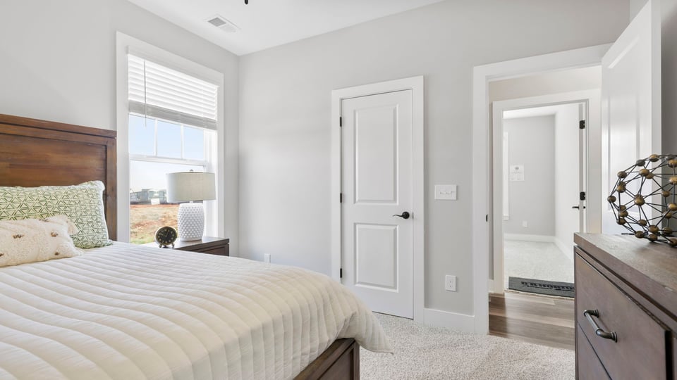 Bedroom with carpet and window.