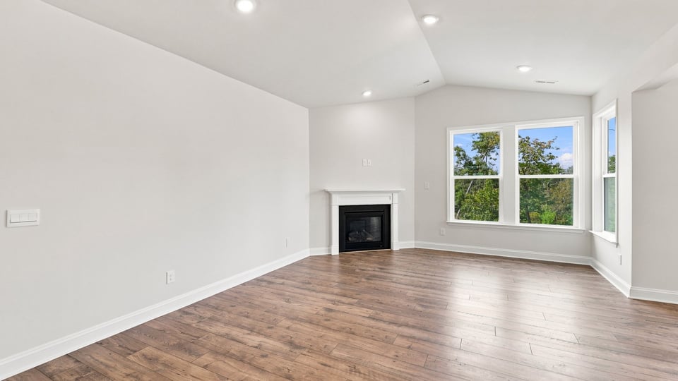 Living room with windows and fireplace.