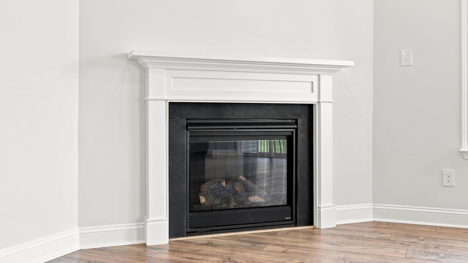 Living room with windows and fireplace.