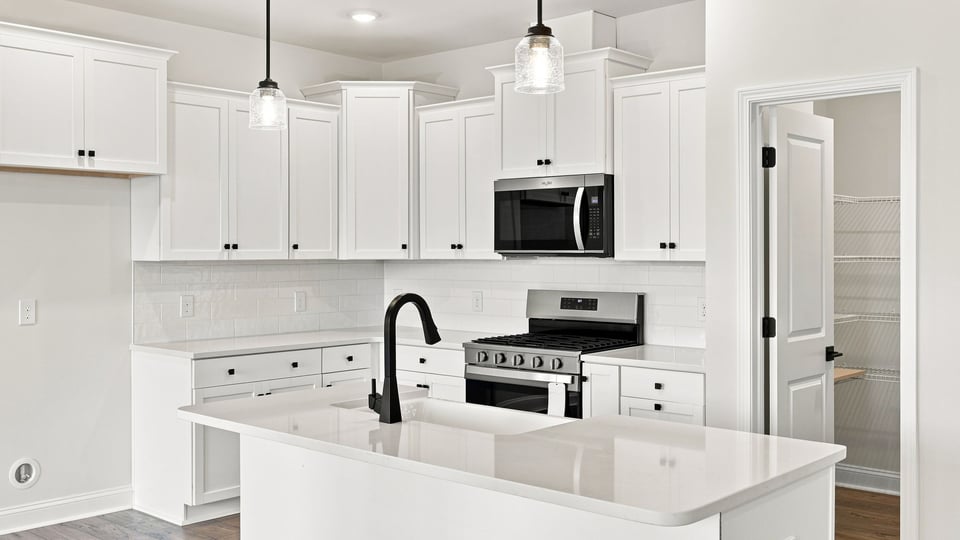 Kitchen and island with quartz countertops.