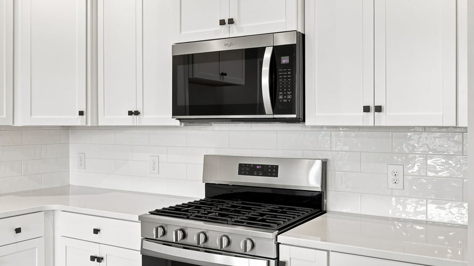 Kitchen and island with quartz countertops.