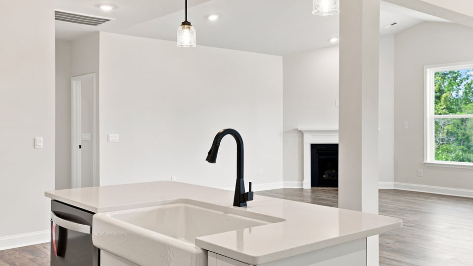 Kitchen and island with quartz countertops.