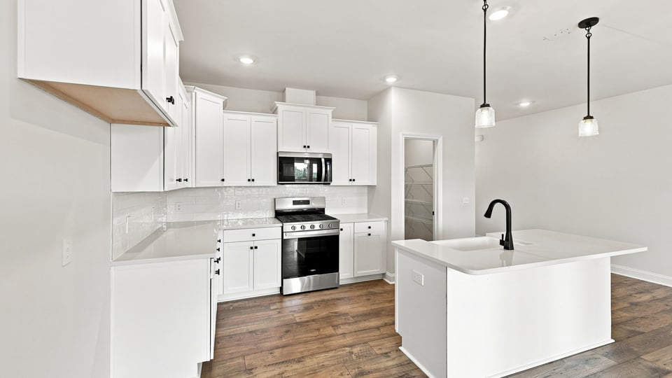 Kitchen and island with quartz countertops.