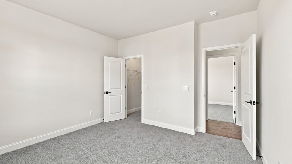 Bedroom with carpet and window.